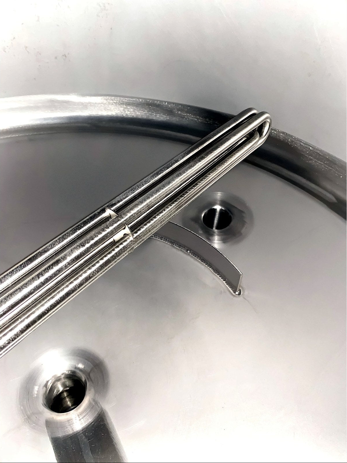 Close-up of the rake arm and bottom outlet inside the BrewTaurus PRO 200L vessel