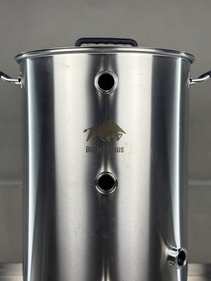 K80 Boil Kettle — close-up of the 1.5" Tri-Clamp front ports, the whirlpool port and the etched BrewTaurus logo