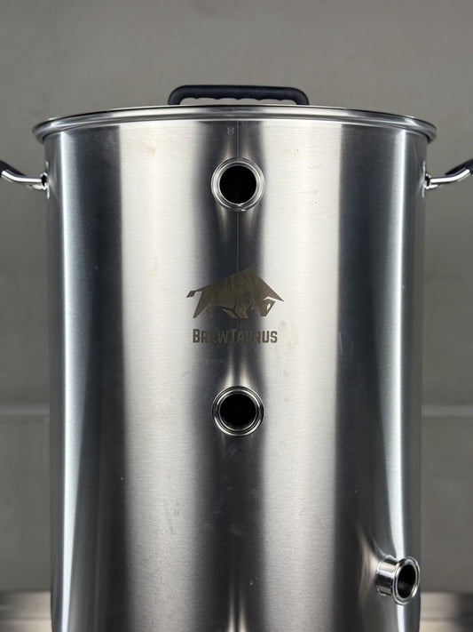 K80 Boil Kettle — close-up of the 1.5" Tri-Clamp front ports, the whirlpool port and the etched BrewTaurus logo